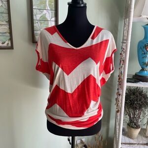 Orange/white Aztec style shirt.